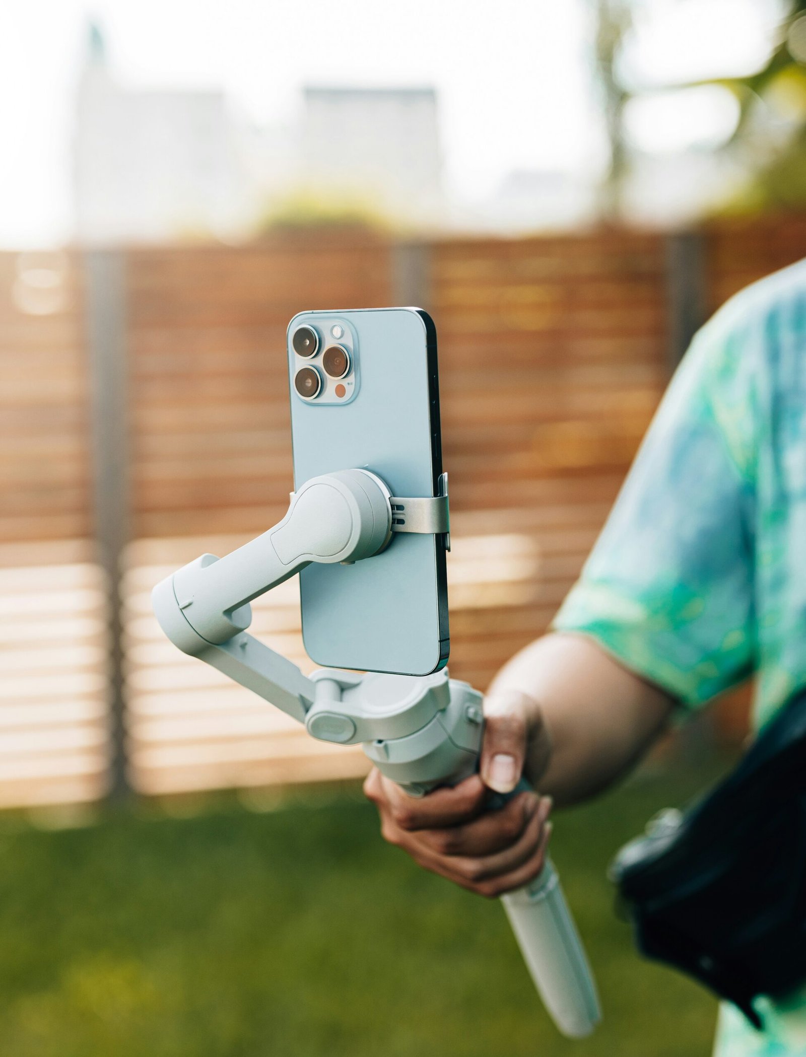 a person holding a cell phone with a camera attached to it